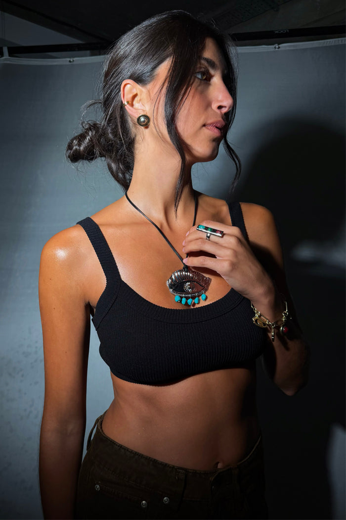 Deloris Silver Circle Earrings in textured brushed metal, styled on a model with an eye pendant and black crop top.