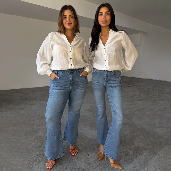Blue Denim Flare Scallop Jean with a 70's silhouette, shown on two models for inclusive sizing.