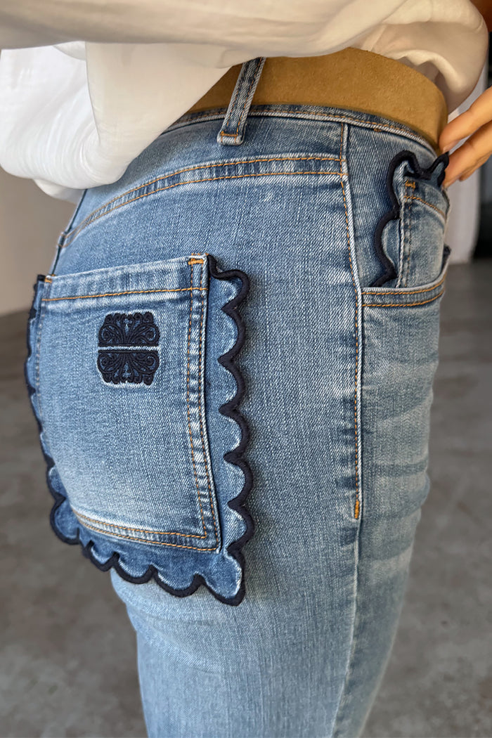 NFD Denim Flare Scallop Jean in blue with navy scalloped pockets and an embroidered logo on the back.