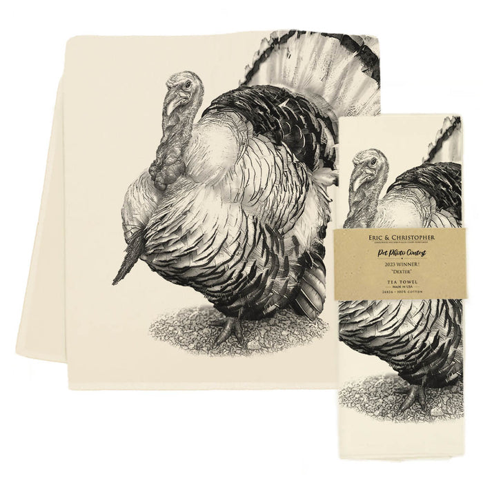 A beige cotton tea towel with a screen-printed black turkey design against a white background.