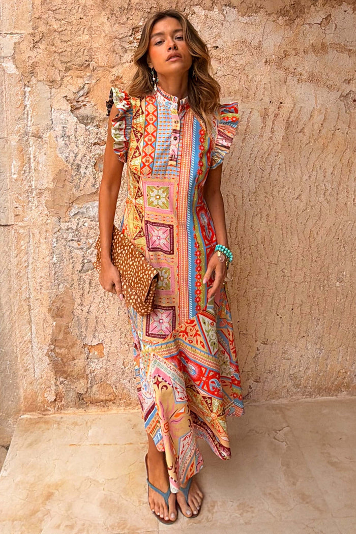 Dolce Vita Remi Dress in a sunset-toned patchwork print with a high neck and statement ruffle sleeves.
