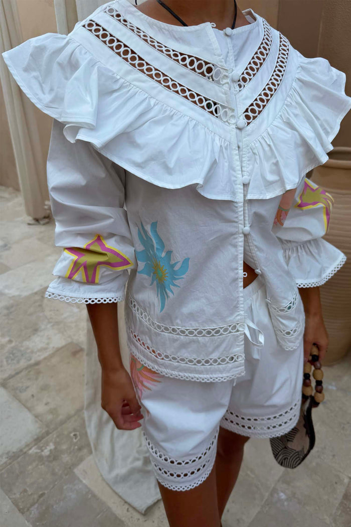 Dreamer Willa Top in white cotton with celestial motifs, a ruffled cutout neckline and matching shorts.