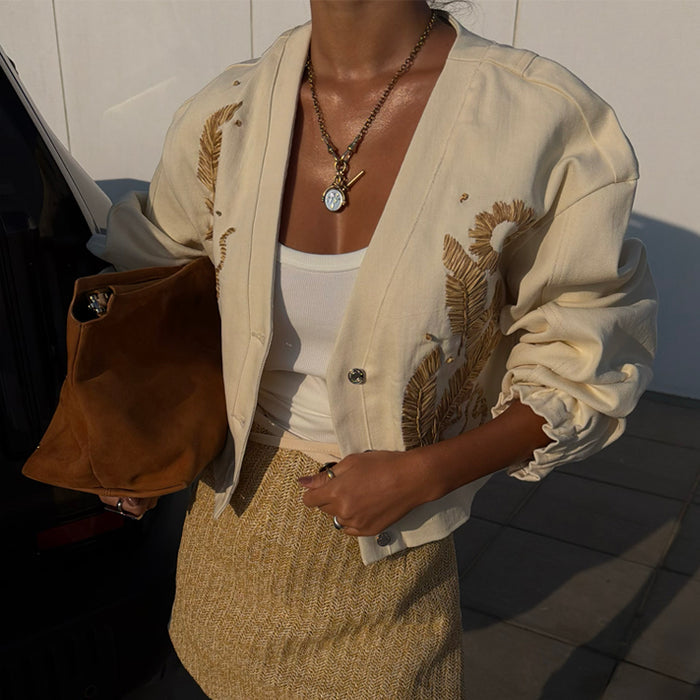 Ecru Cove Raffia Denim Jacket in cream featuring textured palm embroidery, branded buttons and elasticated cuffs.