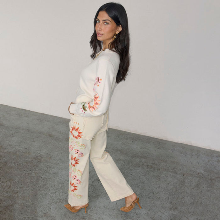 Ecru Enchanted Cut Work Scallop Jeans with sun embroidery and wide-leg fit, paired with a matching cardigan.