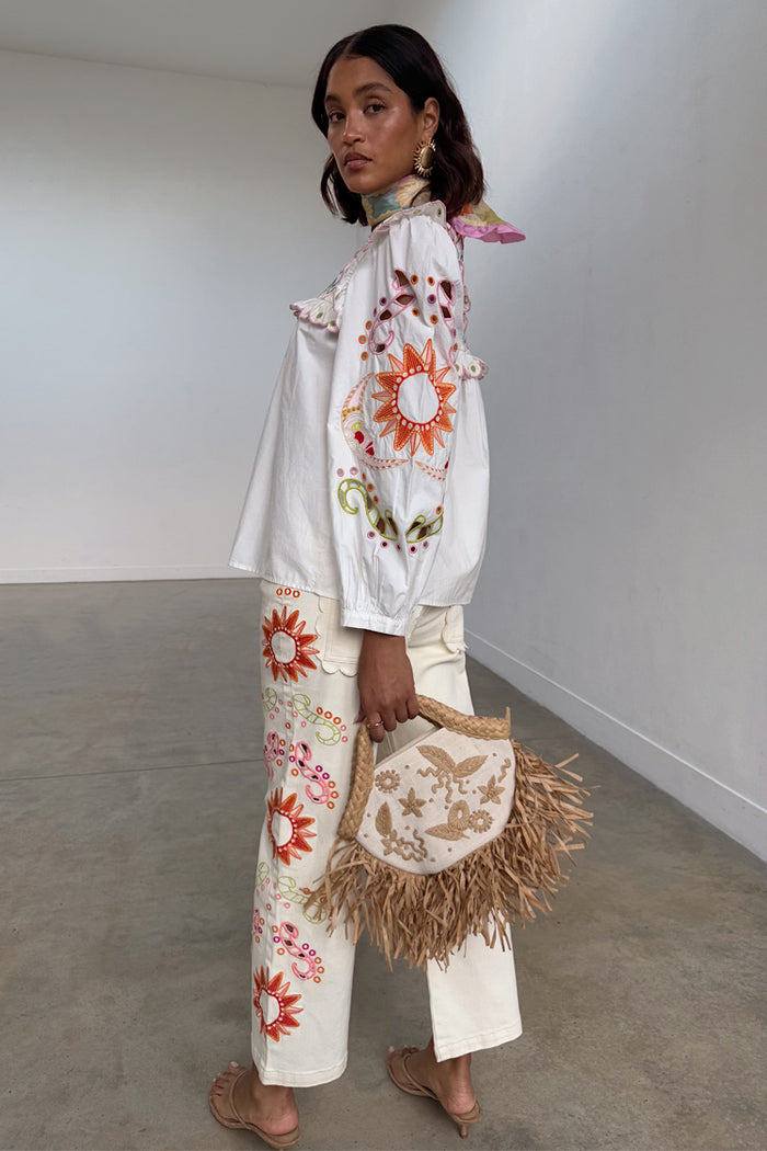 Ecru Enchanted Cut Work Scallop Jeans featuring colourful sun embroidery and a wide-leg silhouette.