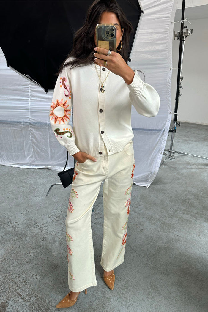 Ecru Enchanted Cut Work Scallop Jeans with colourful embroidery and a wide-leg fit, shown in a studio mirror selfie.
