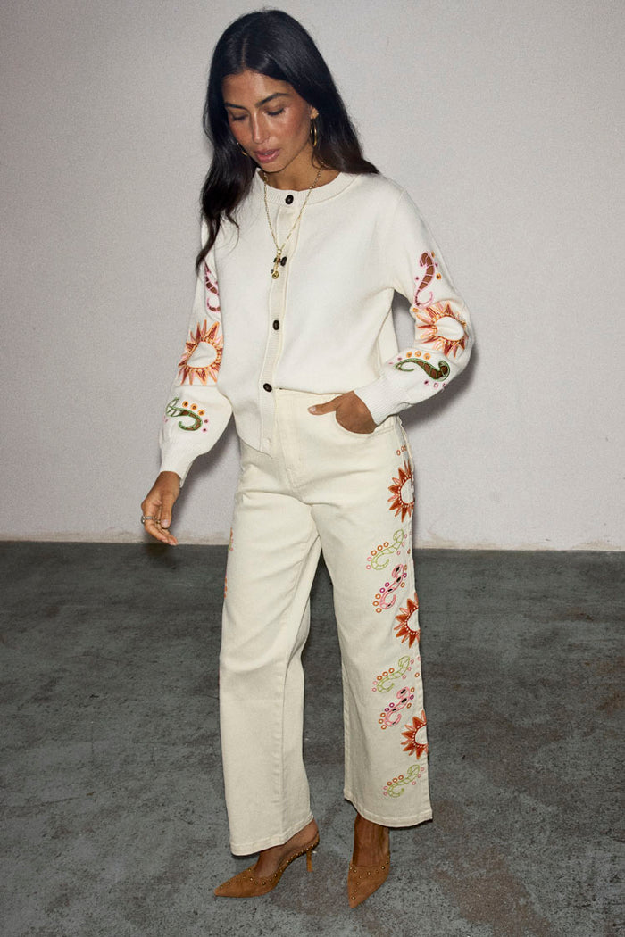 Ecru Enchanted Cut Work Scallop Jeans featuring sun embroidery and a wide-leg fit, paired with a matching cardigan.