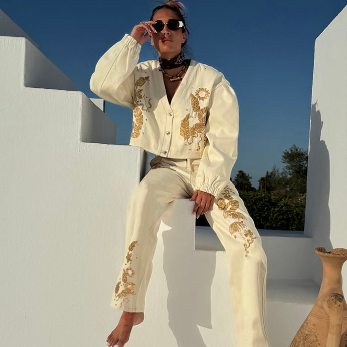Ecru Raffia Palma Barrel Leg Jeans with brown palm embroidery, styled with a matching jacket on white stairs.