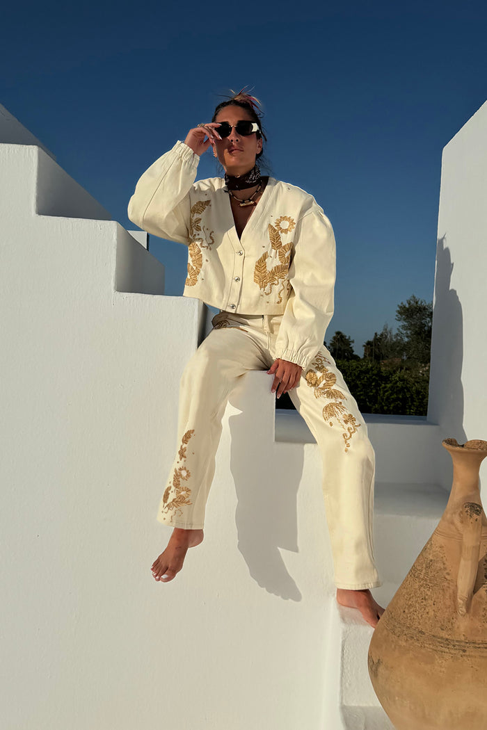 Ecru Raffia Palma Barrel Leg Jeans with textured palm embroidery, styled as a co-ord on white outdoor stairs.