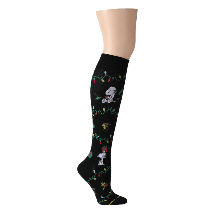 Black knee-high compression socks featuring Snoopy and Woodstock with festive holiday lights.