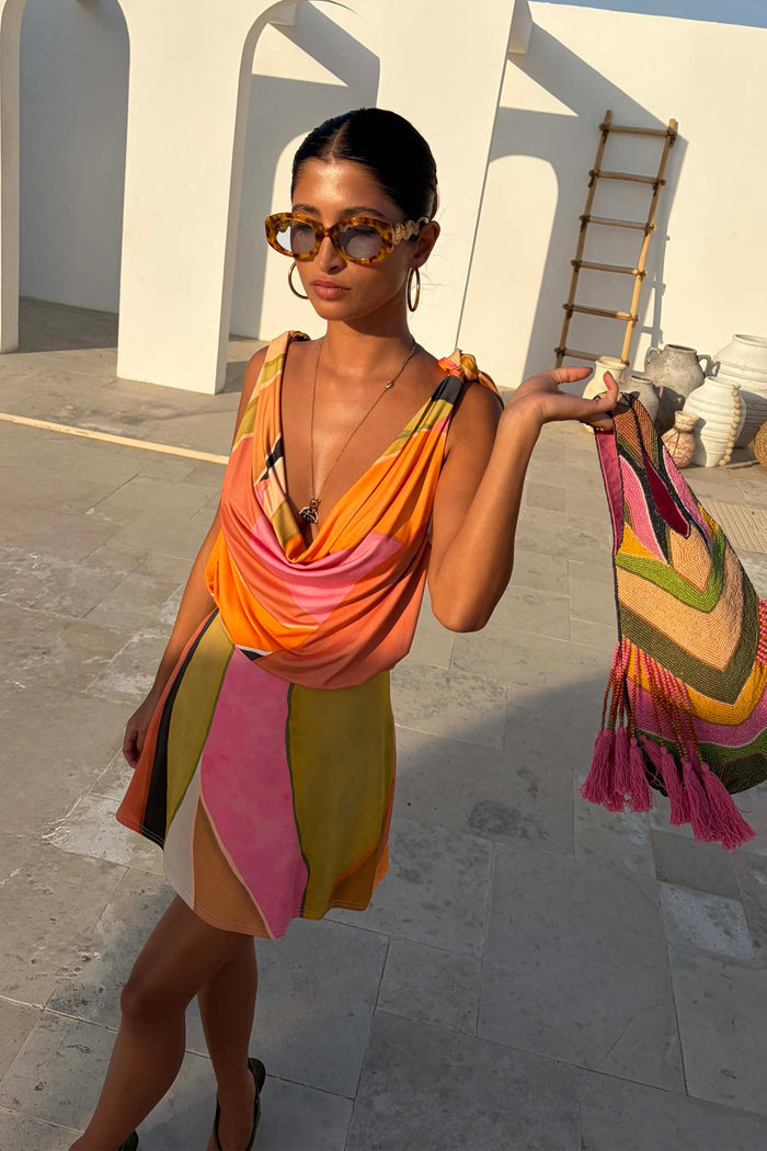 Green Abstract Leila Mini Dress with a cowl neck and adjustable multi-wear straps in a colourful print.
