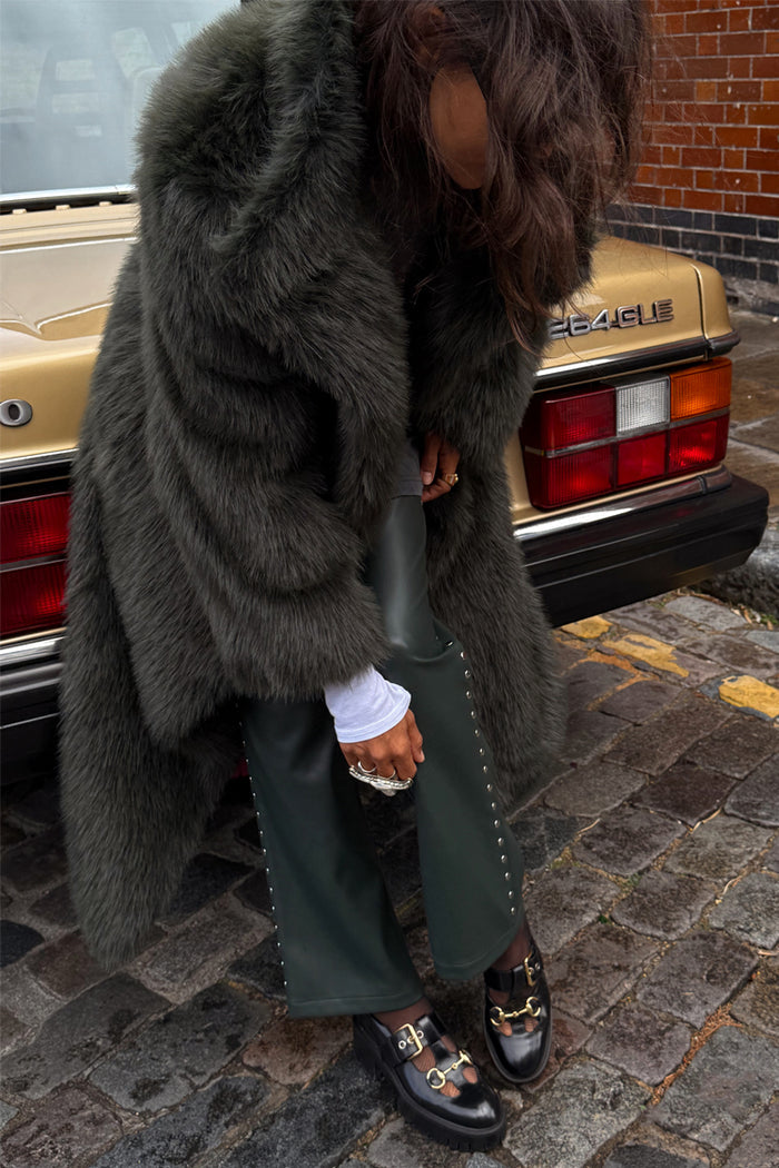 Green Faux Fur Coat in a relaxed silhouette, styled as a statement staple for a London street look.
