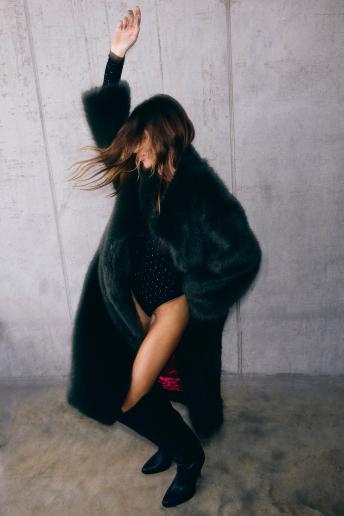 Green Faux Fur Coat in a relaxed silhouette, styled over a black bodysuit for a statement look.