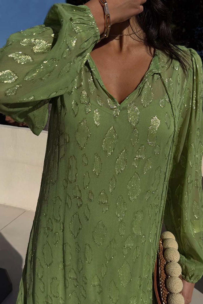 Green Jacquard Harmony Dress in olive green with gold animal print, tassel neck and elasticated cuffs.