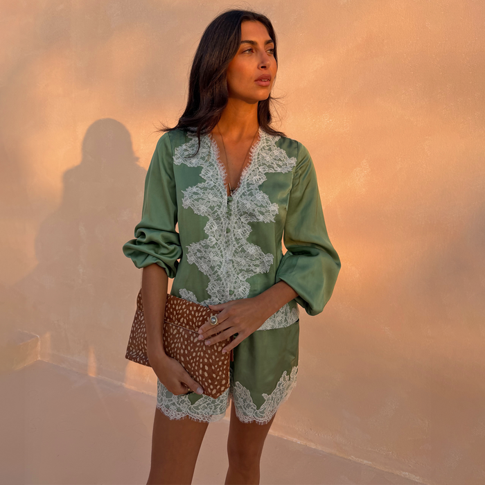 Green Romi Top in satin with white lace detailing, button-down front and voluminous sleeves on a model.