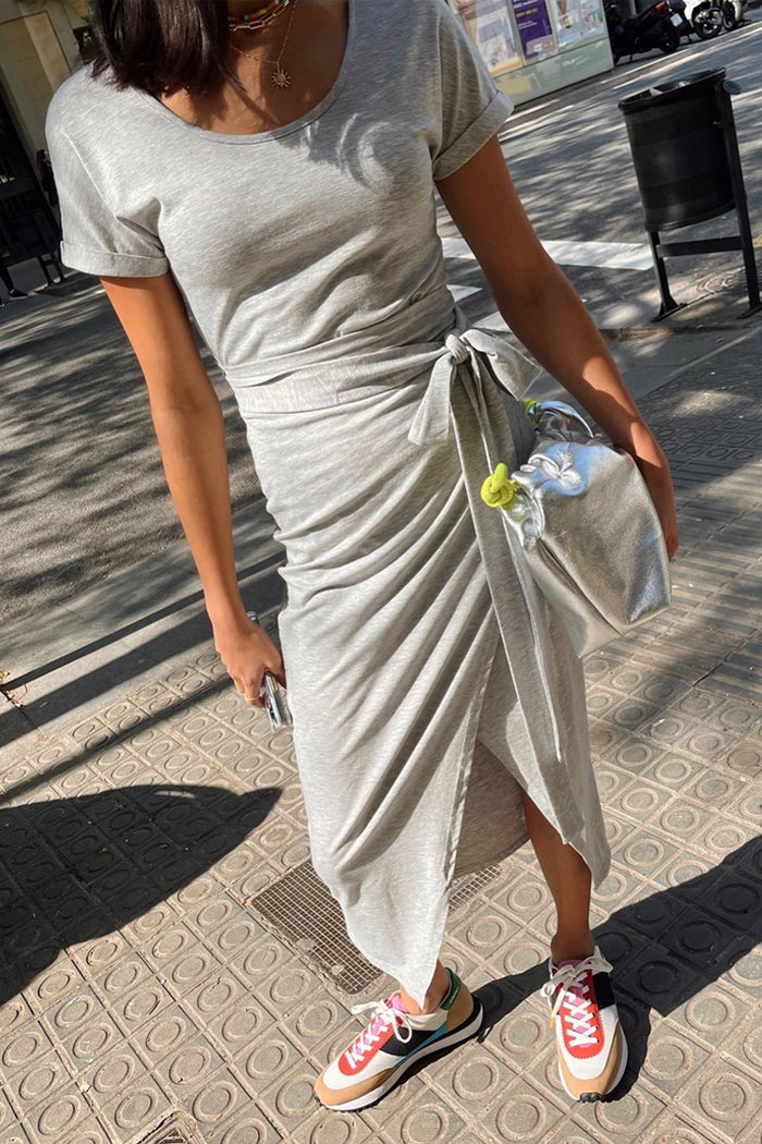 Grey Jesse Jersey Wrap Dress with a multi-wear tie waist, styled with trainers and a silver bag for a London look.
