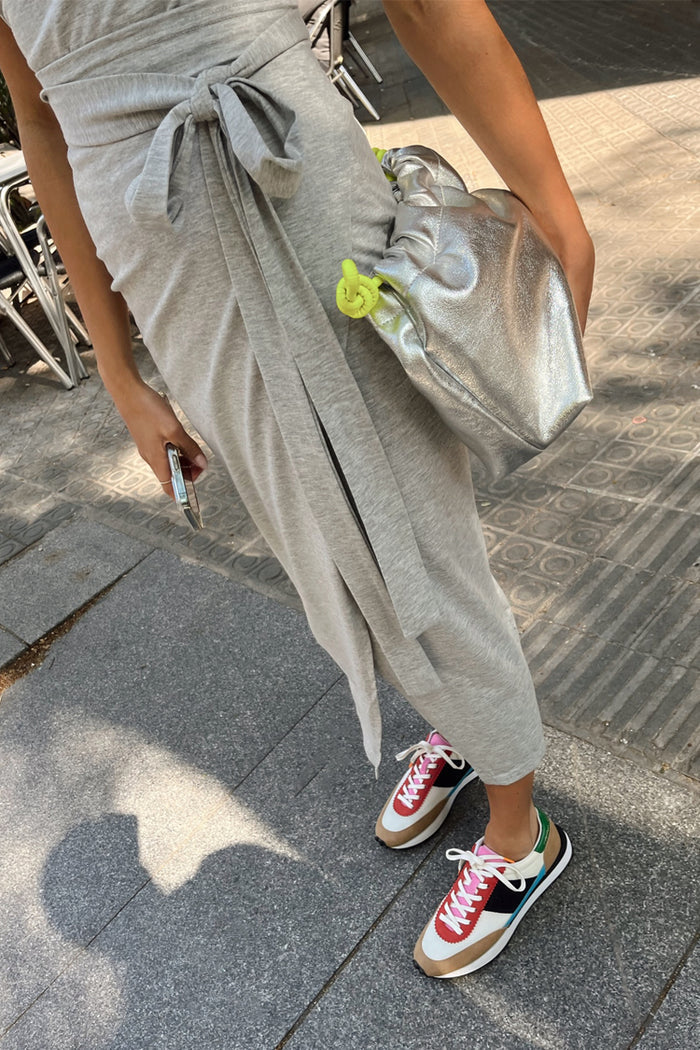 Grey Jesse Jersey Wrap Dress with a multi-wear tie, styled with colourful trainers and a silver metallic bag.