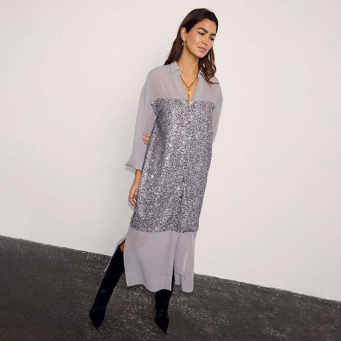 Gunmetal Sequin Lila Shirt Dress with shimmering silver sequins and a relaxed longline silhouette, styled with black boots.
