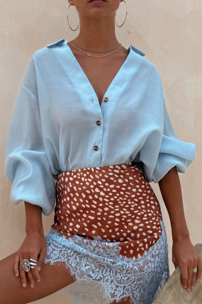Ice Blue Miley Shirt with blouson sleeves and tortoise buttons, a wardrobe staple for a vacation look.