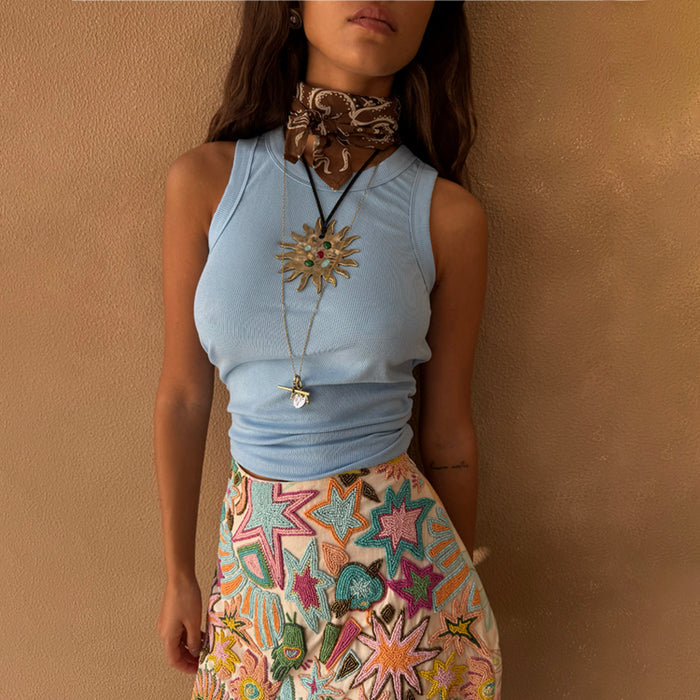 Ice Blue Ribbed Tank Top, a capsule wardrobe staple, styled with a neck scarf and colourful embroidered star skirt.