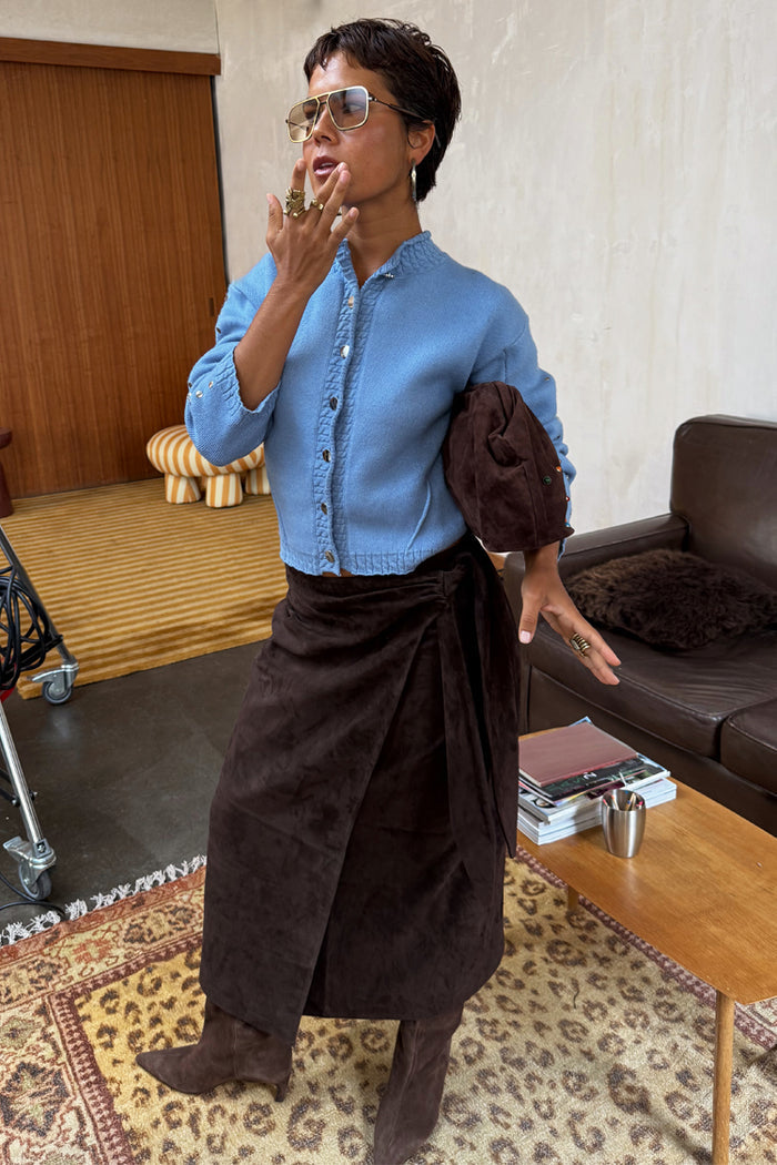 Ice Blue Studded Cardigan with silver sleeve details, styled with a brown wrap skirt and matching boots.