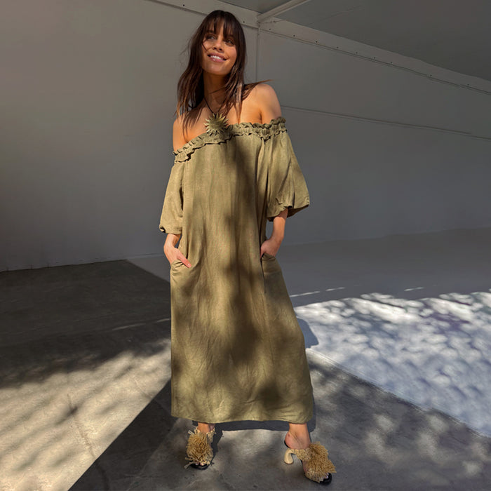 Khaki Ella Dress in a green linen blend with a ruffled neckline, styled off-the-shoulder with side pockets.