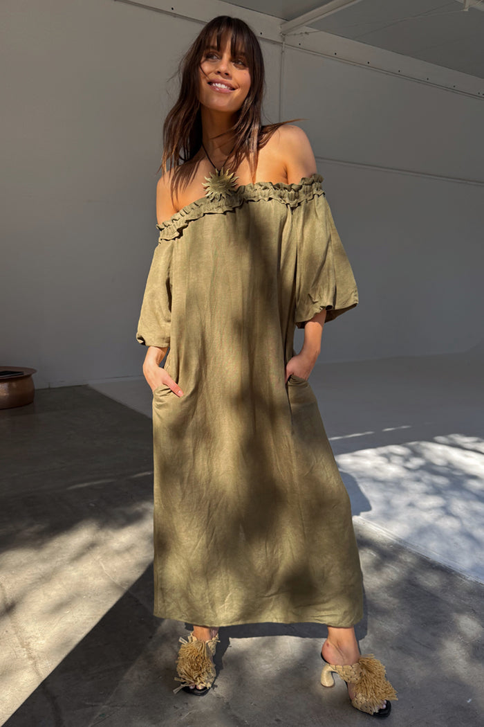 Khaki green Ella Dress in a linen blend with an off-the-shoulder ruffled neckline and side pockets.