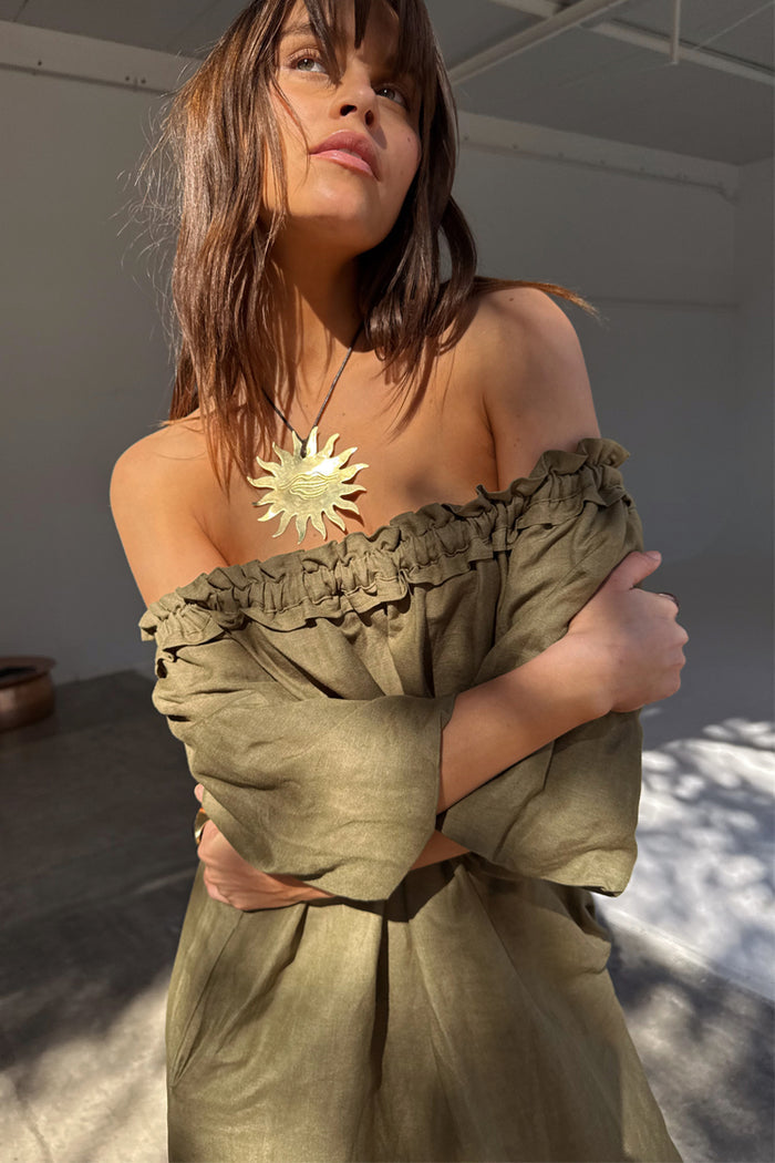 Khaki Ella Dress in a green linen blend with a ruffled neckline styled off-the-shoulder.