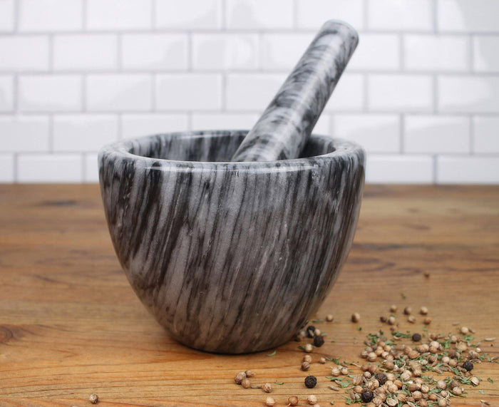 Marble mortar and pestle set by RSVP International, showing a smooth white marble bowl and matching pestle for grinding spices.