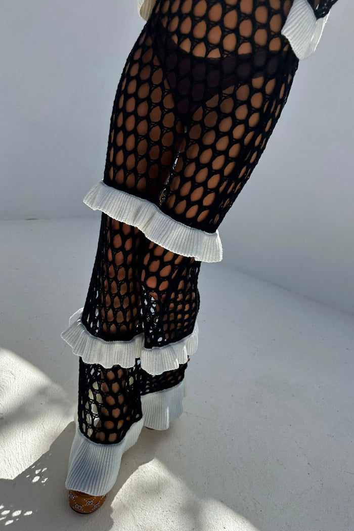 Mono Crochet Chloe Dress with tiered white knitted frills on a black wide crochet fishnet structure.