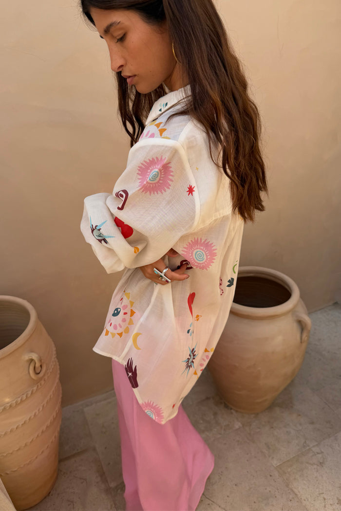 Cream Morocco Charms Marley Shirt featuring vibrant heart and sun motifs in a sheer, oversized silhouette.