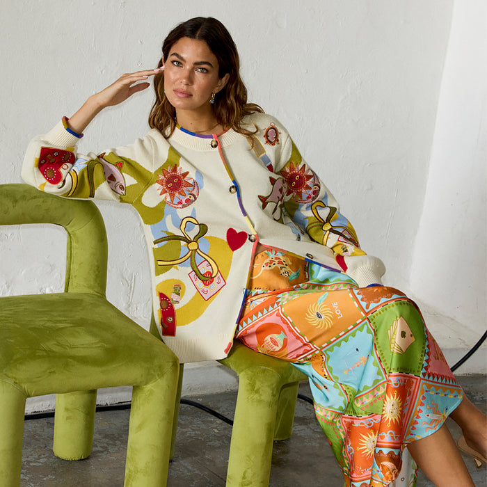Multi Enchanted Cardigan in cream knit featuring sun and heart motifs with a multi-coloured ribbed trim.