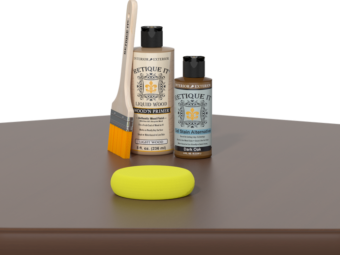 Retique It® Dark Oak Kit with Light Wood’n Primer, Dark Oak Gel Stain Alternative, paintbrush, and yellow sponge on a dark oak tabletop.
