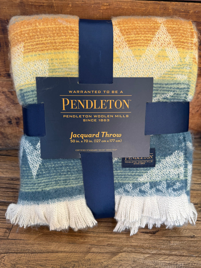 Pendleton jacquard throw blanket with blue, orange, mustard geometric pattern and fringe.