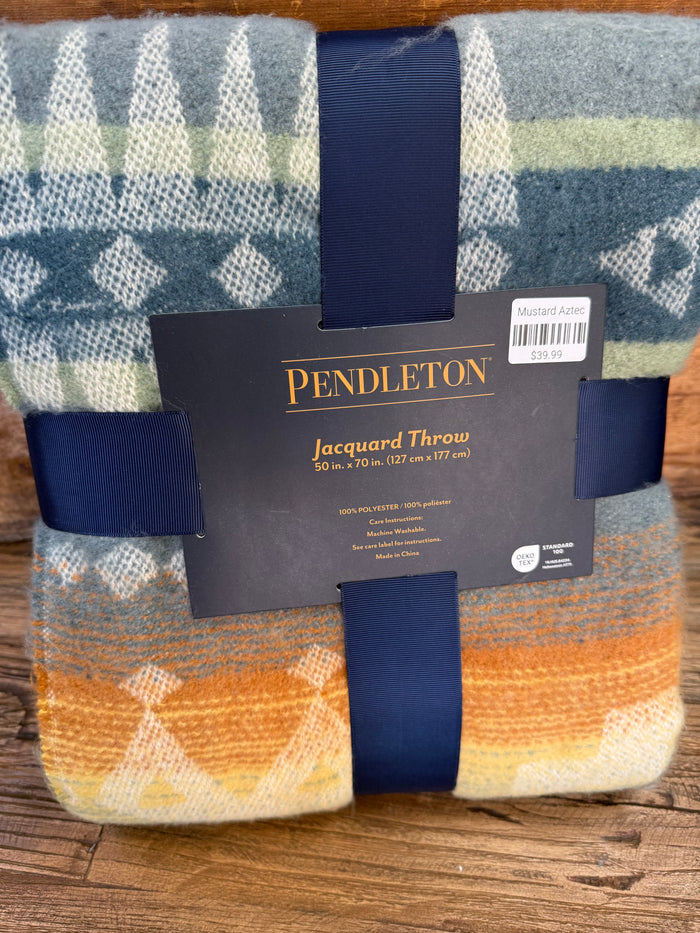 Oversized jacquard throw blanket, navy and cream geometric pattern.