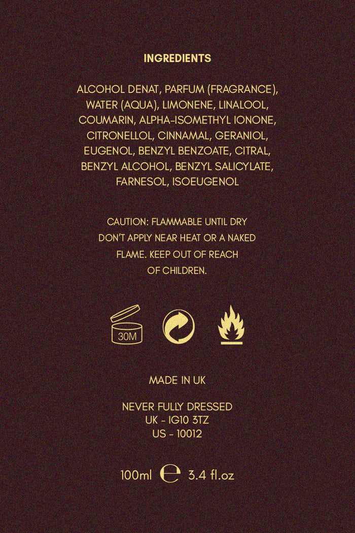 NFD Eau De Parfum 001 ingredient list and safety icons in gold text on a dark, textured background.