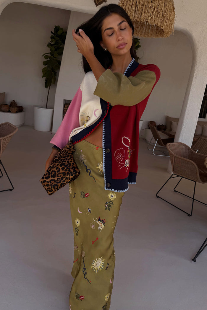 Olive Mystical Dorris Skirt with sun and moon motifs, paired with a colour-block cardigan and leopard print bag.