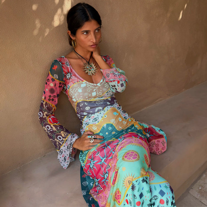 Sheer Pastel Morocco Mesh Vivi Dress with sun, eye and palm motifs in multi-coloured block prints, styled on a model.