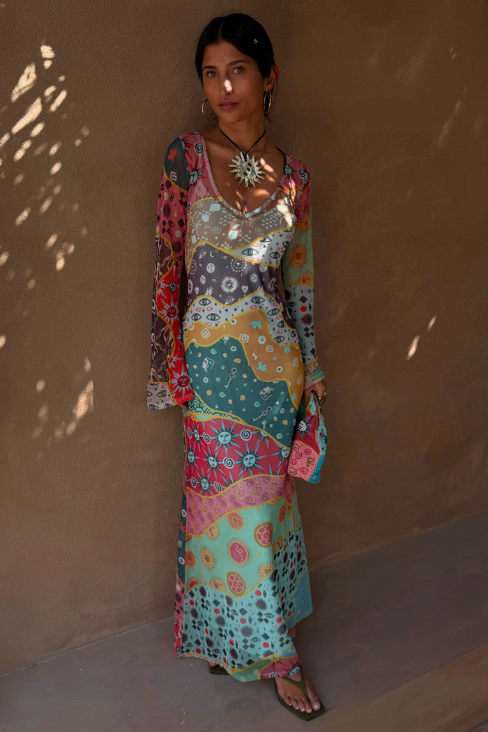 Pastel Morocco Mesh Dress with multi-coloured sun and eye motifs, long sleeves and V-neckline.