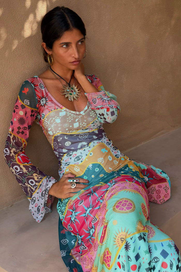 Pastel Morocco Mesh Dress featuring sun and eye motifs in a multi-colour patchwork print on a model.