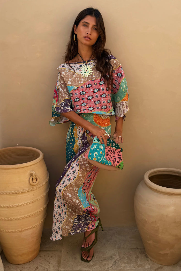 Pastel Morocco Tilly Dress in metallic fleck print with abstract blocks and iconic sun and eye motifs.