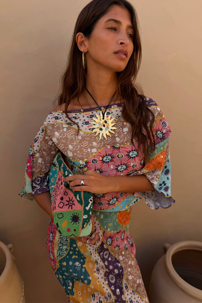 Pastel Morocco Tilly Dress in a multi-coloured metallic fleck print with iconic sun motifs and voluminous sleeves.
