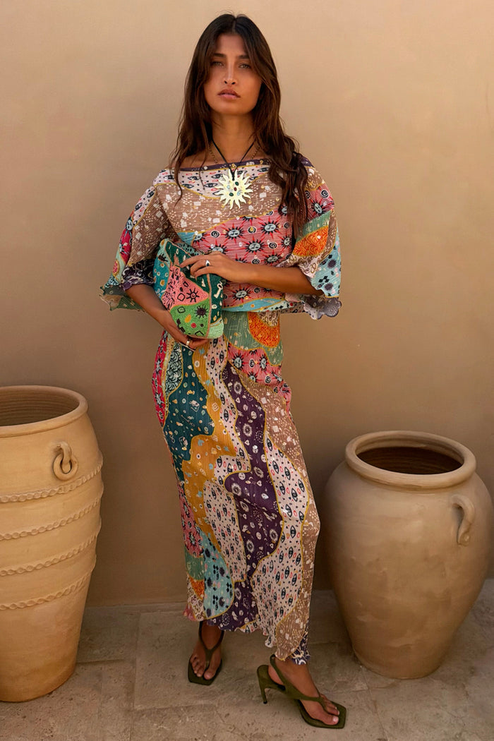 Pastel Morocco Tilly Dress in a multicoloured metallic fleck print with iconic sun motifs and a matching clutch bag.