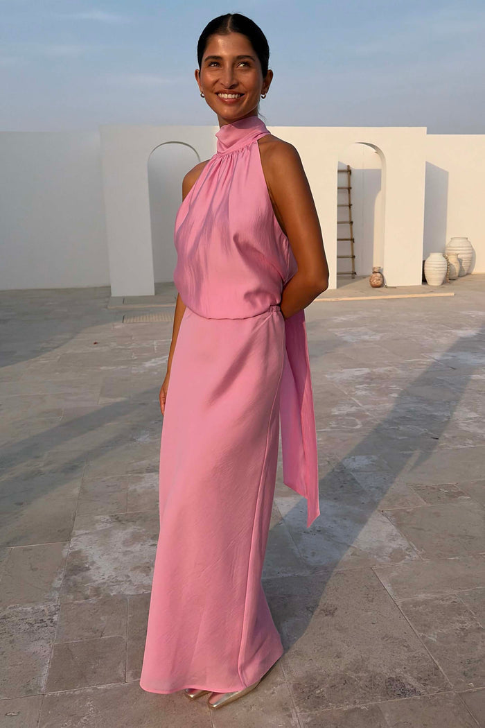 Pink Billie Top with a high halterneck and multi-wear ties, styled as a co-ord with a matching pink maxi skirt.
