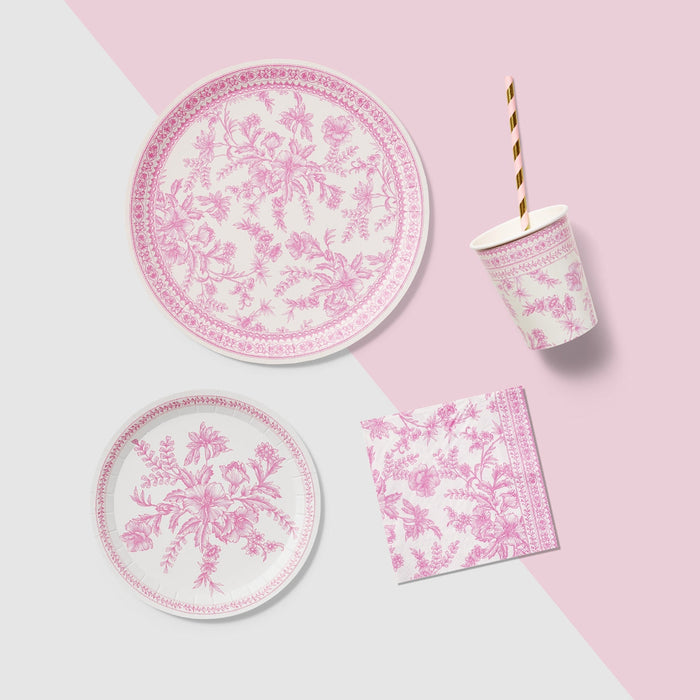 A table set with Pink French Toile Paper Party Dinnerware plates from Coterie Party Supplies featuring floral toile dinnerware patterns that evoke the charm of the French countryside, complemented by silverware.