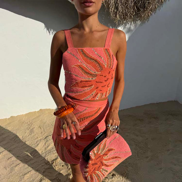 Pink Sol Beaded Top with a hand-embroidered sun motif and gold sequins, styled for a beach vacation.