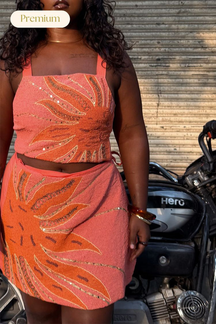 Pink Sol Beaded Top and skirt co-ord with hand-embroidered sun motifs and gold sequins, shown on a model.