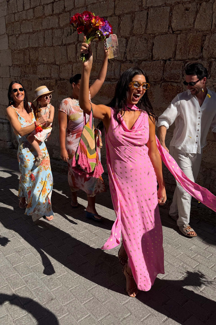 Pink Sophie Dress with shimmering gold flecks and a multi-wear scarf, styled for a celebratory wedding guest look.