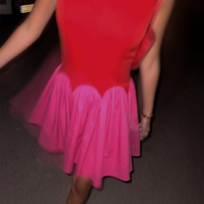 Red and Pink Mini Monika Dress with a red bodice, scalloped waistline and pleated pink skirt.