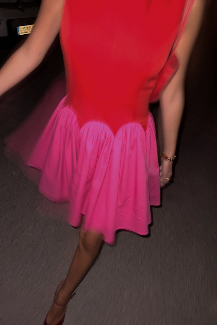 Red and Pink Mini Monika Dress with a scalloped waistline and pleated skirt, captured in a night-out motion shot.
